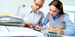 14726879 - portrait of two businesswomen working with papers in office